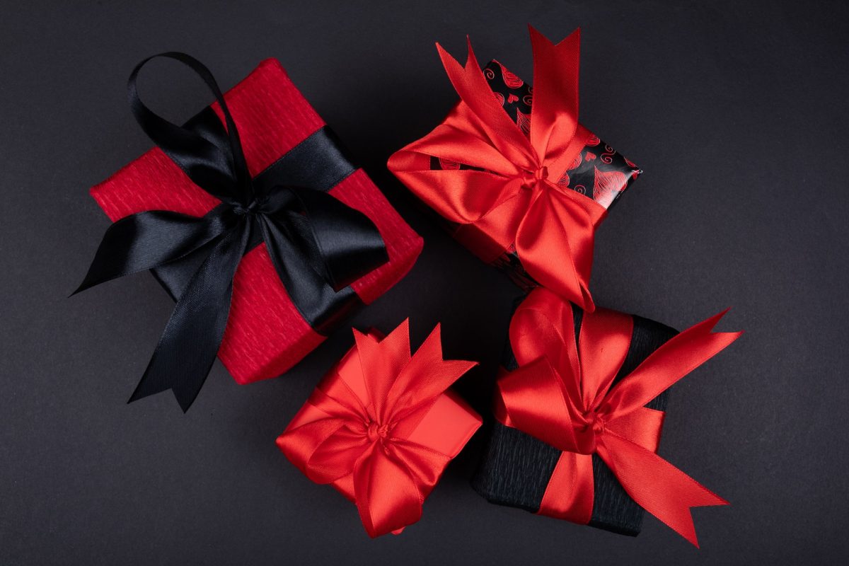 Four corporate anniversary gifts with red and black wrapping paper.